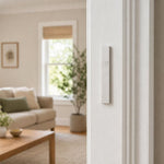 Minimalist Wave silver aluminum mezuzah cover mounted on a modern doorpost with a waterproof profile and curved Shin detail