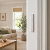 Minimalist Wave silver aluminum mezuzah cover mounted on a modern doorpost with a waterproof profile and curved Shin detail