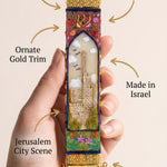 Person holding a decorative mezuzah made of Jerusalem-inspired design with a subtle, minimalist presentation.
