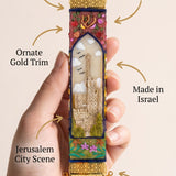 Person holding a decorative mezuzah made of Jerusalem-inspired design with a subtle, minimalist presentation.