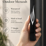 sculpted silver Shin with a polished finish against the smooth black face of the waterproof seven-inch acrylic mezuzah case, suitable for modern outdoor doorposts