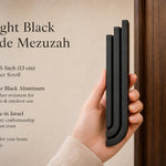 Person holding the Midnight Black Cascade Mezuzah showing detail and texture for online listing.