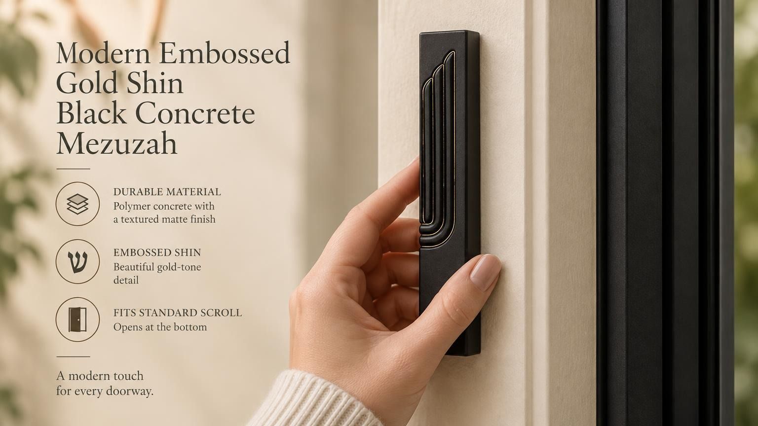 A hand holding a modern black concrete mezuzah case featuring an embossed gold Hebrew Shin letter.