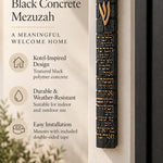 Extra large black Birkat HaBayit concrete mezuzah mounted on a front doorpost, showing its 8.5-inch height and raised gold Hebrew details