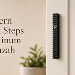 Modern Black Steps waterproof aluminum mezuzah case mounted vertically on a light-colored doorpost, featuring layered architectural black fins and a contrasting silver Hebrew Shin, made in Israel for modern indoor and outdoor Jewish doorways
