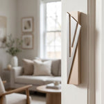 Modern Capital Shin champagne mezuzah cover mounted on an apartment doorpost with a waterproof profile and brushed silver geometric detail