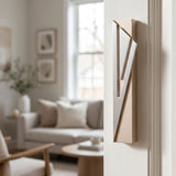 Modern Capital Shin champagne mezuzah cover mounted on an apartment doorpost with a waterproof profile and brushed silver geometric detail