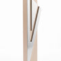 Modern Capital Shin champagne aluminum mezuzah case on white with a tall rectangular body and a large angular silver Hebrew Shin