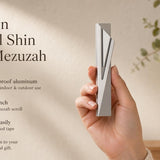 Hand holding the Modern Capital Shin Gray Mezuzah showing its design, material, and dimensions, suitable for indoor and outdoor use.