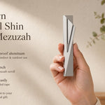 Hand holding the Modern Capital Shin Gray Mezuzah showing its design, material, and dimensions, suitable for indoor and outdoor use