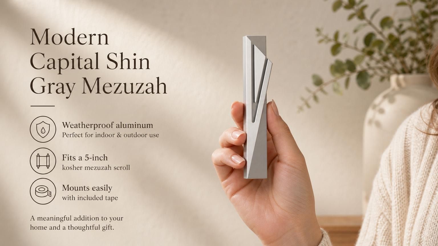 Hand holding the Modern Capital Shin Gray Mezuzah showing its design, material, and dimensions, suitable for indoor and outdoor use