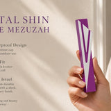 Hand holding a silver and purple aluminum mezuzah case in a premium editorial style with a Capital Shin mezuzah specifications highlighting the 5.5-inch body, 5-inch kosher scroll fit, and Israeli construction