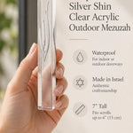 Close-up of the sculpted silver Shin and transparent sides of the waterproof seven-inch clear acrylic mezuzah case for outdoor use