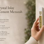 Handheld close view of a modern white cement mezuzah case with a raised gold Hebrew Shin and luminous golden crystal and glass inlay, presented with product features in a contemporary home setting to show its scale, finish, and decorative detail