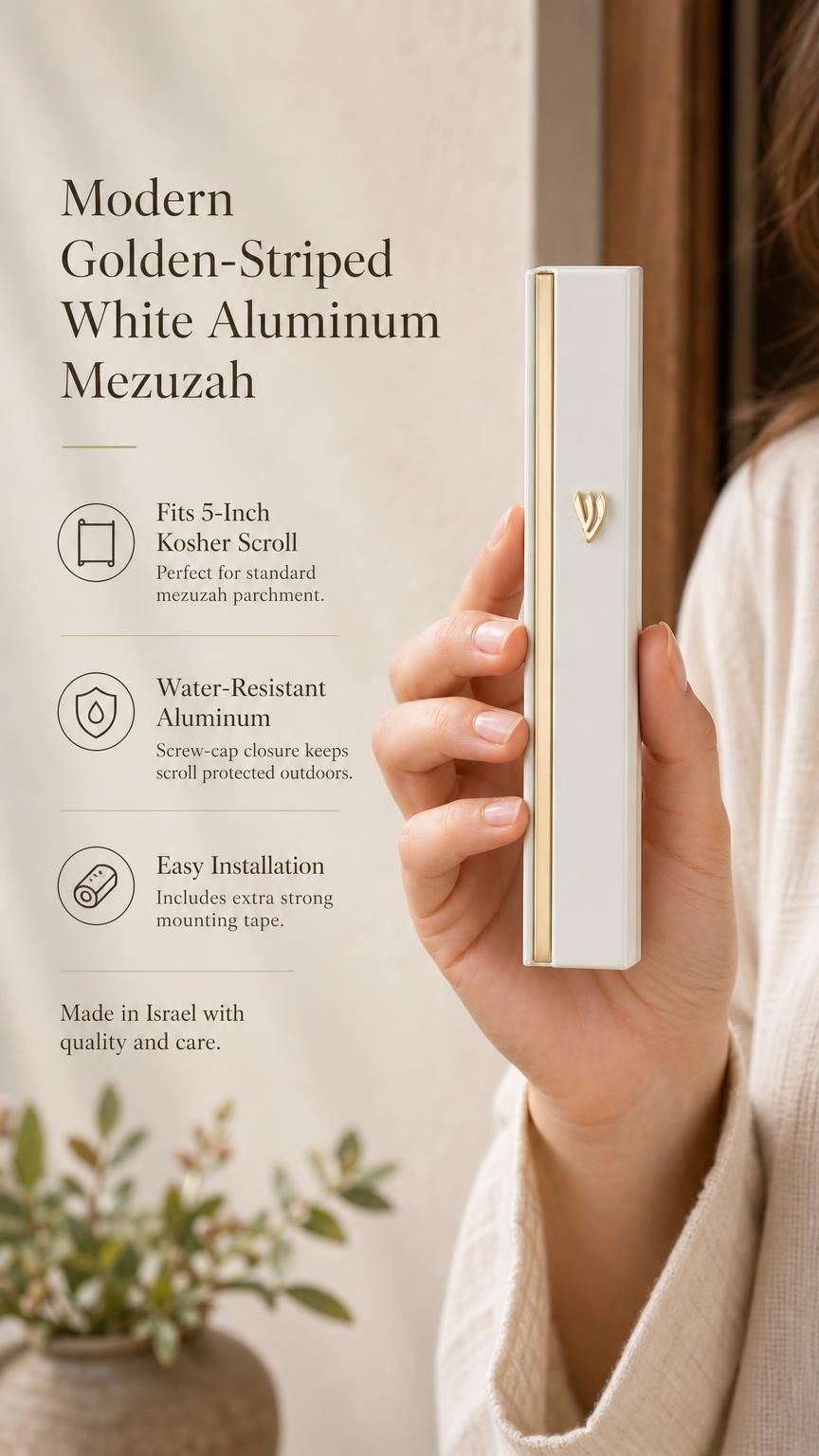 Person holding a white and gold aluminum mezuzah showing its sleek design with natural light and generous space.