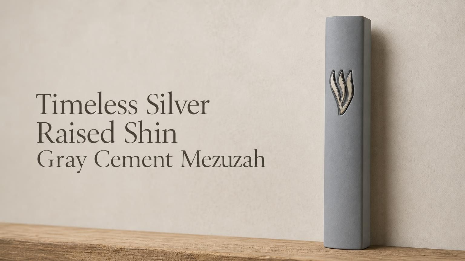 Minimalist gray cement mezuzah case featuring a raised silver Hebrew letter Shin on a soft, neutral stone-colored background