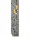 Detailed view of a handcrafted Jerusalem stone Mezuzah in gray, with intricate Hebrew engravings, on a clean white studio background with soft reflection.