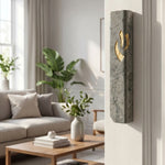 Handcrafted Jerusalem stone mezuzah in gray and gold mounted on a narrow interior doorway in a modern home interior.
