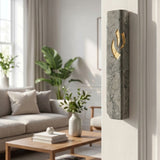 Handcrafted Jerusalem stone mezuzah in gray and gold mounted on a narrow interior doorway in a modern home interior.