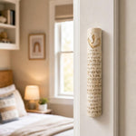 Jerusalem Stone Mezuzah case with gold Hebrew lettering, mounted on a residential doorpost in a lifestyle setting.