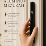 Modern black aluminum mezuzah case with Shin detail, designed for outdoor doorways with secure screw-in cap and water resistance.