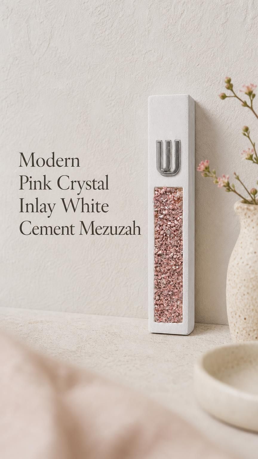 Modern white cement mezuzah displayed against a soft minimalist background with a raised silver-tone Shin and decorative pink crystal and glass inlay, showing blush, rose, pale pink, and reflective tones in a clean contemporary Judaica design
