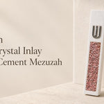 unique modern white cement mezuzah with a raised silver-tone Shin and a vertical panel of pink, rose, blush, and translucent crystal and glass inlay, styled against a soft neutral backdrop