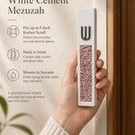 Hand holding a Modern Pink Crystal Inlay White Cement Mezuzah case with a raised silver-tone Shin and sparkling pink, blush, rose, and translucent crystal and glass pieces set into the slim white cement body