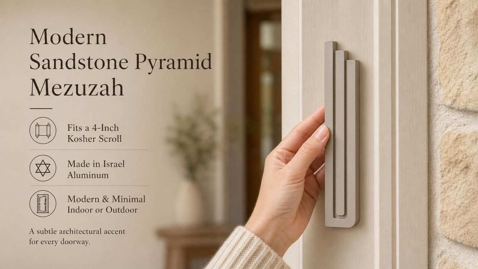 Person holding the exact modern sandstone pyramid mezuzah, showing its architectural form and warm greige aluminum finish, with editorial text beside