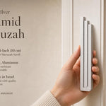 Person holding the exact silver pyramid mezuzah with editorial text on opposite side, showcasing its sleek design and modern style.