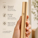 Person holding a modern waterproof gold aluminum outdoor mezuzah, showing its streamlined design and reflective gold finish.
