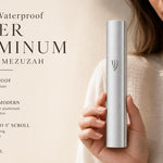 Hand holding a modern waterproof silver aluminum outdoor mezuzah with a sleek design and smooth silver finish