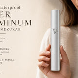 Hand holding a modern waterproof silver aluminum outdoor mezuzah with a sleek design and smooth silver finish