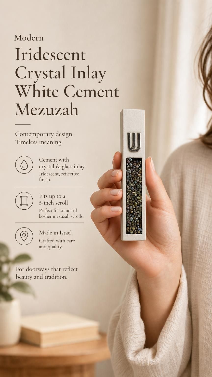 Handheld view of a modern white cement mezuzah case with a raised silver-tone Shin and dense iridescent crystal and glass inlay, shown beside product information in a neutral home setting to highlight the contemporary design, slim proportions, and reflective finish