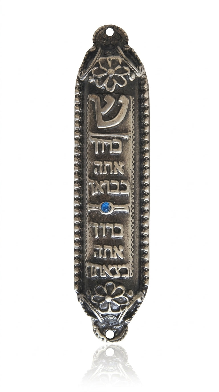 Petite Moroccan style pewter Mezuzah with Hebrew blessing, suitable for home doorways, featuring intricate details and placed on a white studio surface.
