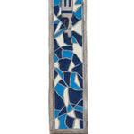 Detailed mosaic pewter mezuzah with Hebrew engravings, designed for doorpost decoration, with a polished white studio background and subtle reflection.