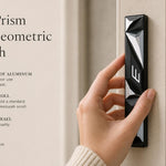 Black and silver geometric mezuzah mounted on a residential doorpost in a natural, well-lit home interior.