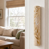 Jerusalem stone mezuzah mounted vertically on a residential doorpost in a natural indoor setting, showcasing its elegant design and materials.