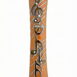 Orange pewter mezuzah with musical symbols, treble clef, decorated stones, suitable for home doors, glossy finish, handcrafted in USA.