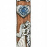 Rich mahogany wooden mezuzah with pewter bride and groom, designed for interior doors or a wedding gift, with a polished white background and subtle reflection.