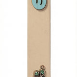 Light blue wooden baby boy mezuzah with silver shoes and blue sequins for doorpost decoration, displayed vertically against a white studio background with soft reflection.