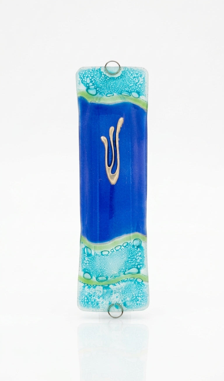 Elegant glass mezuzah with Hebrew inscriptions, displayed on a clean white studio background with soft reflection, showcasing fine details.