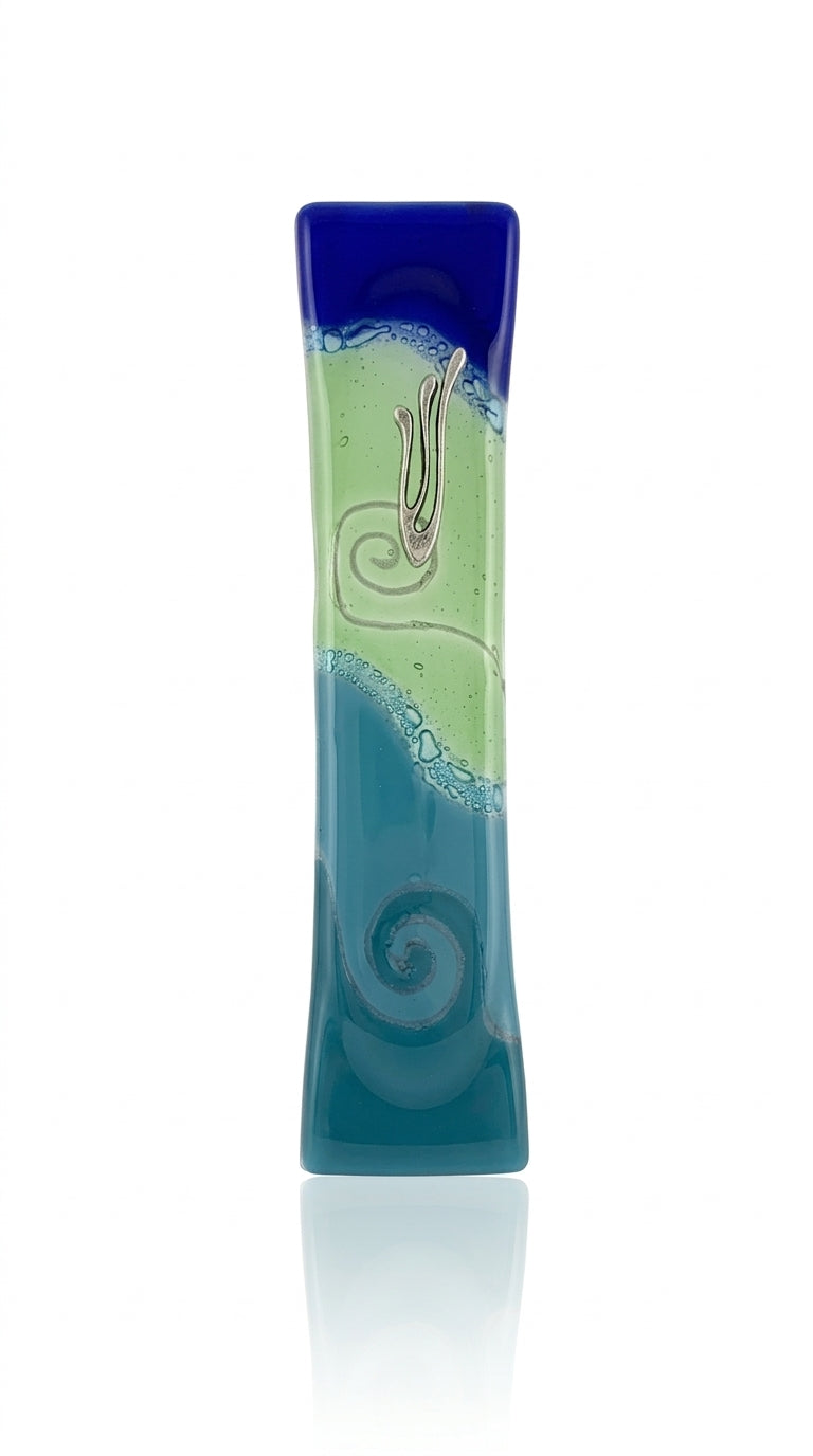 Detailed Ocean Glass Mezuzah with Hebrew inscription, displayed on a white studio background with soft reflection, showcasing fine craftsmanship and texture.