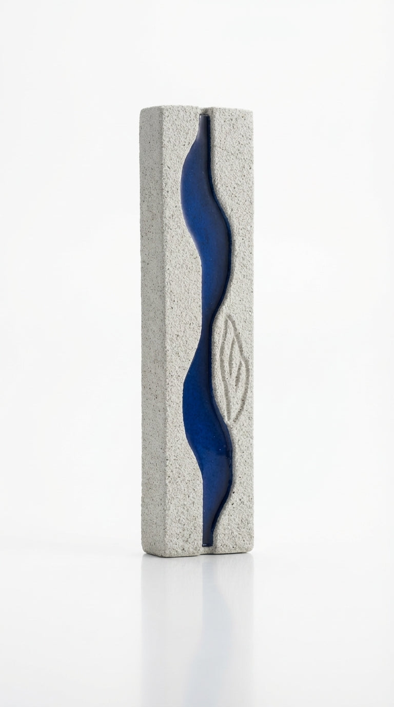 High-resolution image of the Oceanside Mezuzah with detailed engravings, Hebrew letters, and decorative motifs on a white studio background with a soft reflection.