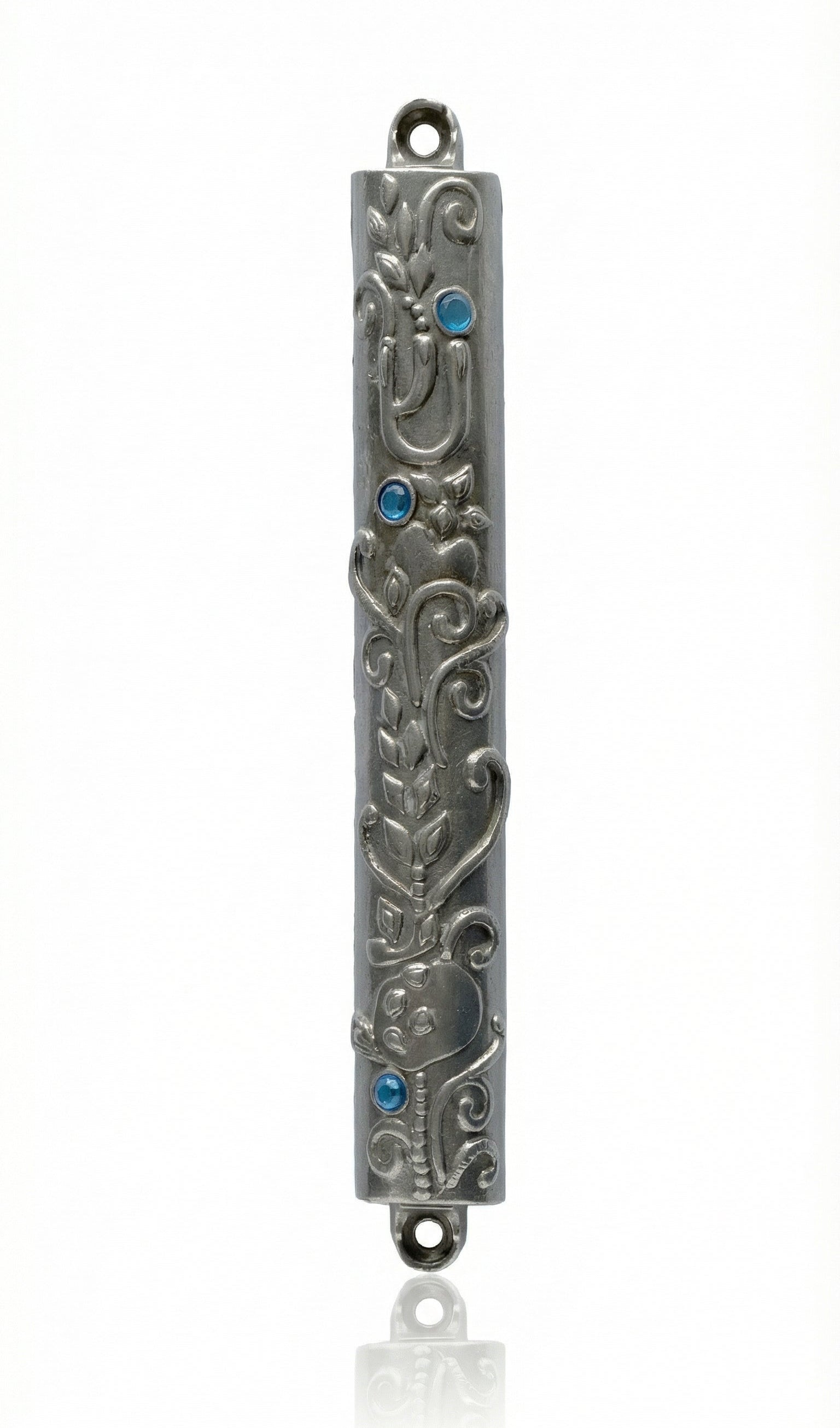 High-resolution image of an Ofir Mezuzah made of pewter, standing 7 inches tall, with intricate engraved Hebrew letters and decorative motifs, on a white studio background with soft reflection.