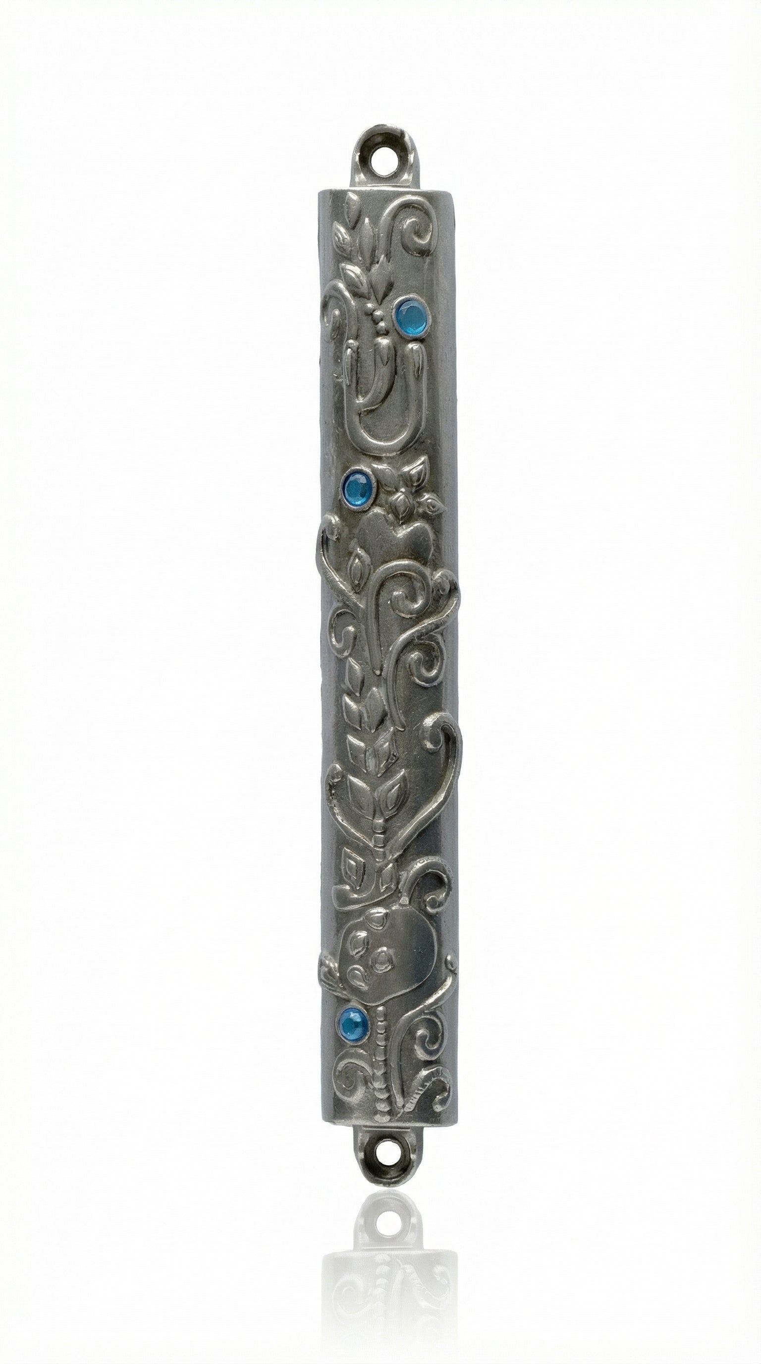 High-resolution image of an Ofir Mezuzah made of pewter, standing 7 inches tall, with intricate engraved Hebrew letters and decorative motifs, on a white studio background with soft reflection.