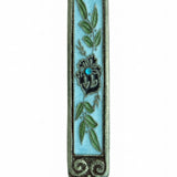 Hand-painted pewter Mezuzah with olive branches, crystal center, and intricate details on white background with soft reflection.