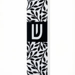 Upscale image of an olive branches mezuzah made of acrylic, with intricate details, Hebrew text, and decorative motifs, on a white studio background with soft reflection.
