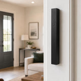 Black aluminum outdoor mezuzah mounted on a doorpost, weather-resistant with screw-cap closure, modern and sleek for contemporary entrances.