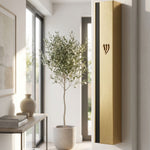 Metal outdoor mezuzah in gold and black aluminum mounted on a doorframe with weather-resistant features.